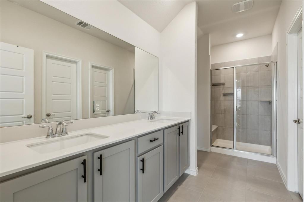 10314 Echo Brk Lane Aubrey, TX 76227 - Photo 7 of 21 Full bath featuring double vanity, light tile patterned floors, a stall shower, and recessed lighting