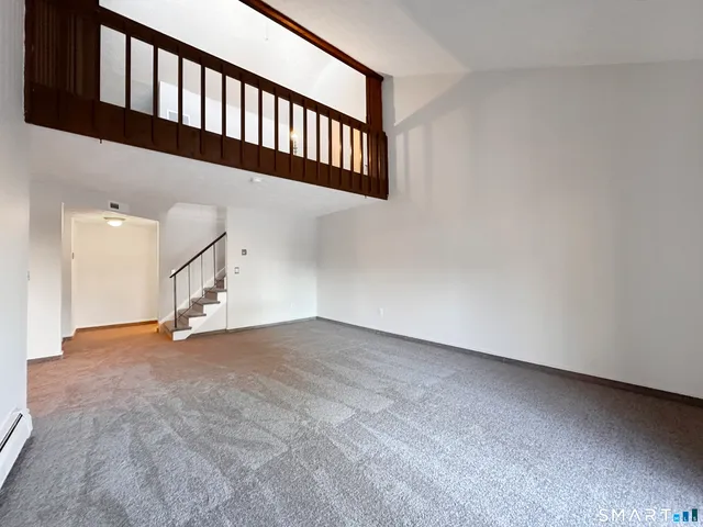 a view of an empty room with stairs