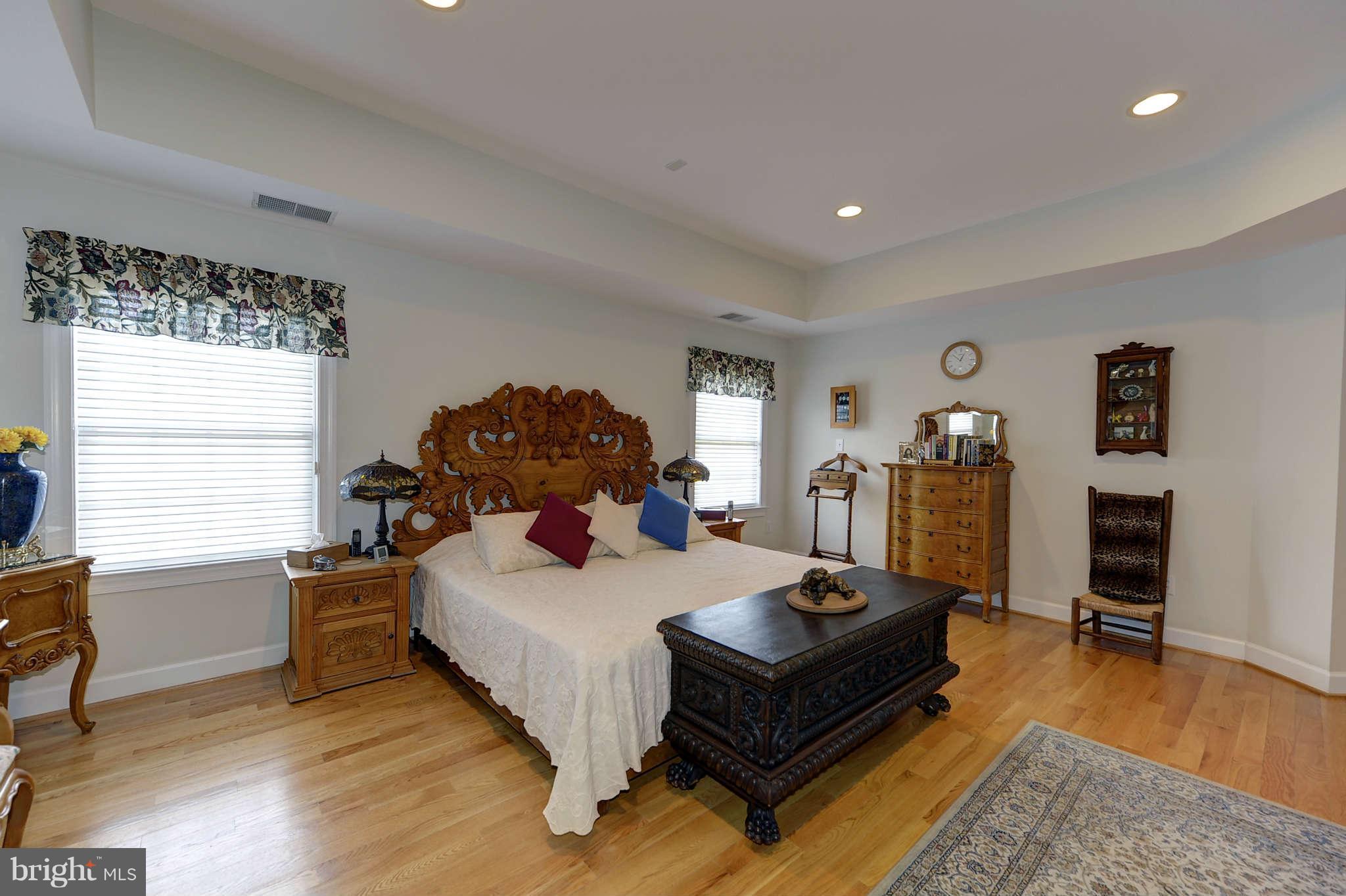 10404 Grey Fox Road Potomac, MD 20854 - Photo 14 of 30 a bedroom with a bed and wooden floor