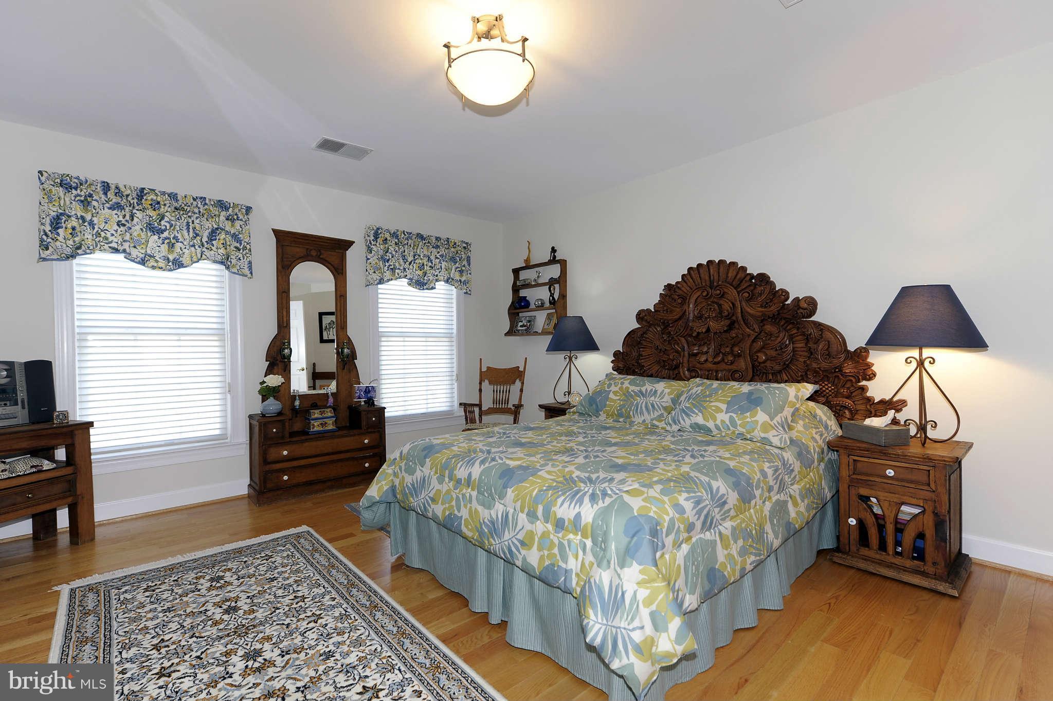 10404 Grey Fox Road Potomac, MD 20854 - Photo 18 of 30 a bedroom with a bed and wooden floor