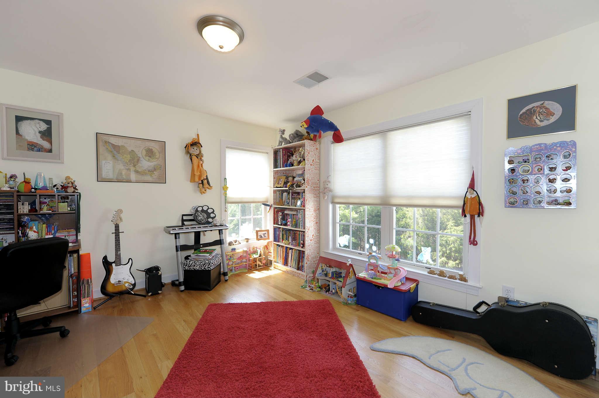 10404 Grey Fox Road Potomac, MD 20854 - Photo 20 of 30 a bed room with a bed couch and a large window