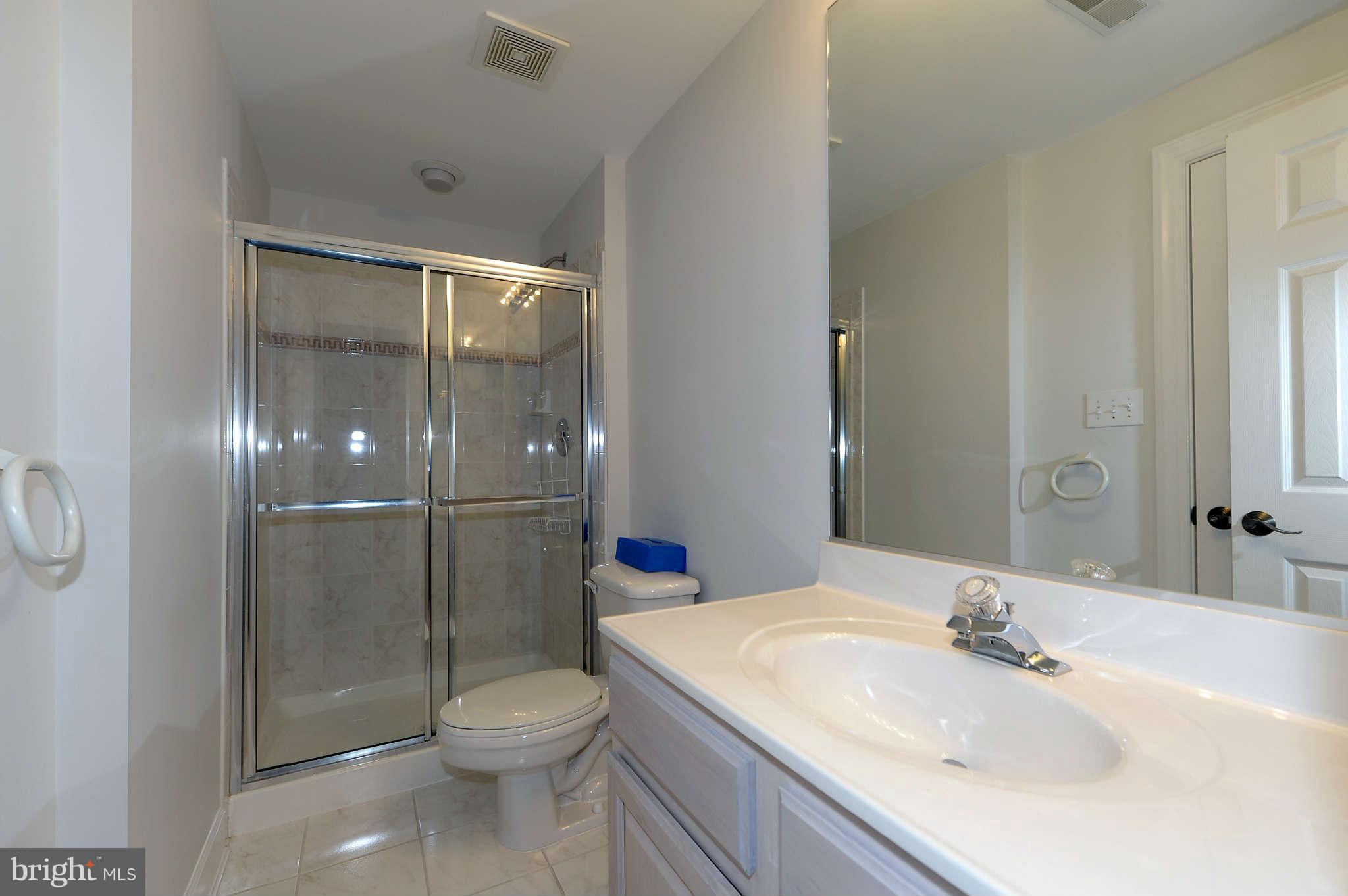 10404 Grey Fox Road Potomac, MD 20854 - Photo 24 of 30 a bathroom with a sink toilet and shower