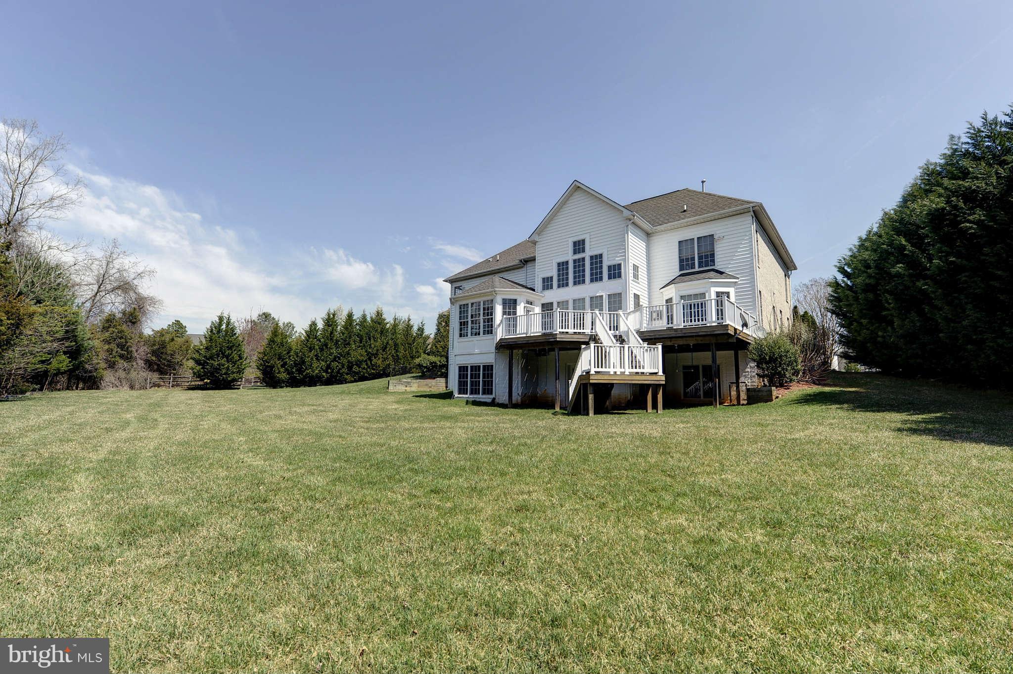 10404 Grey Fox Road Potomac, MD 20854 - Photo 28 of 30 a front view of a house with a yard and garage
