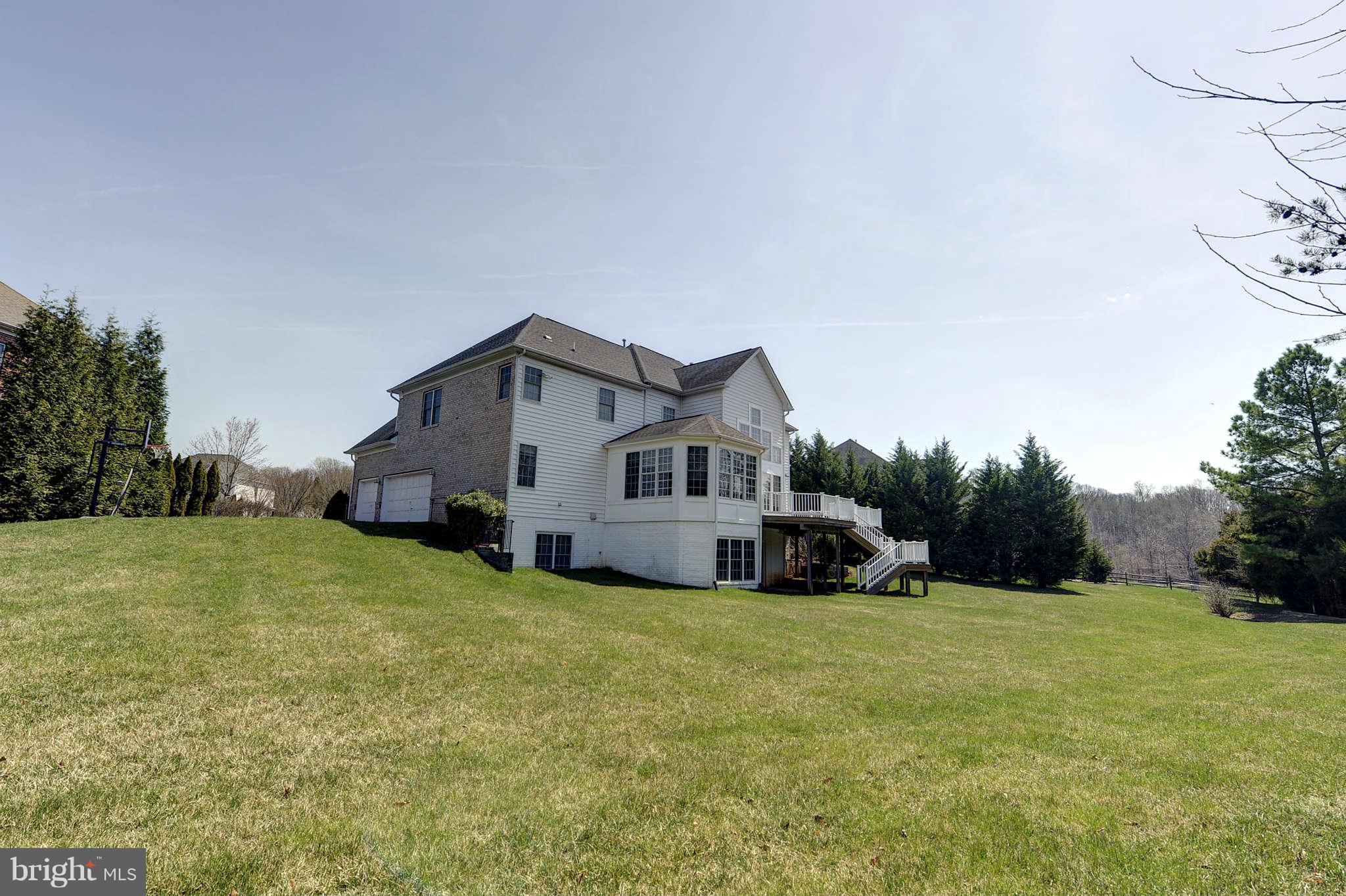 10404 Grey Fox Road Potomac, MD 20854 - Photo 29 of 30 a house that is sitting in the grass with wooden fence