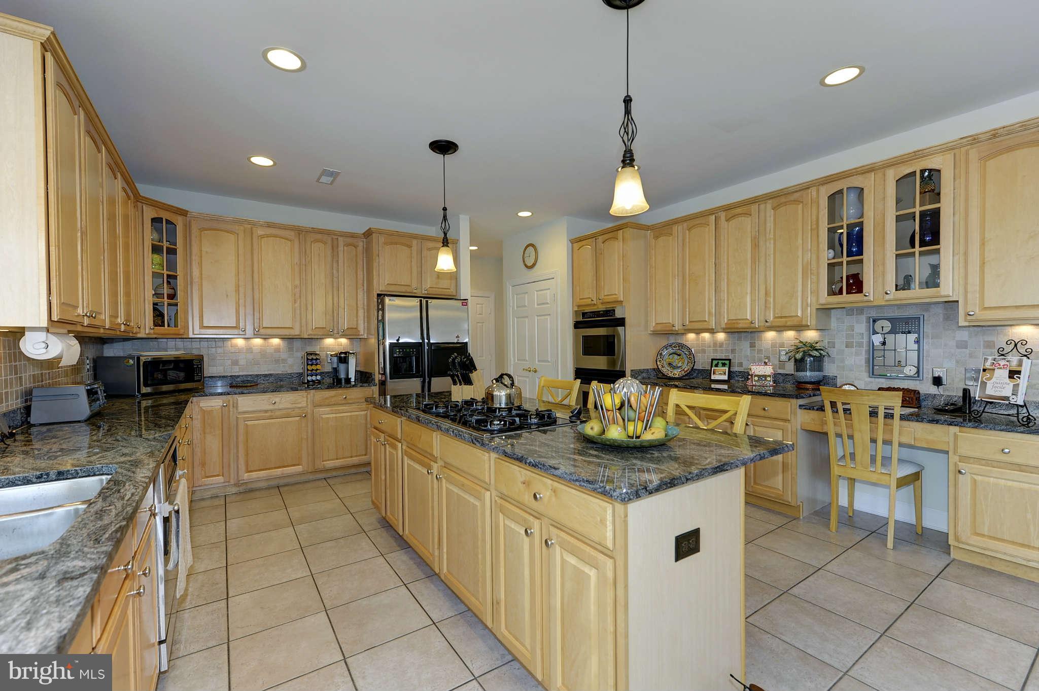 10404 Grey Fox Road Potomac, MD 20854 - Photo 9 of 30 a kitchen with counter top space appliances and cabinets