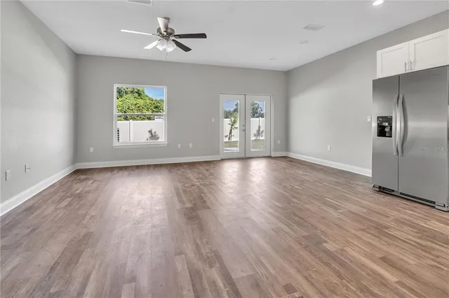 wooden floor in an empty room with a window