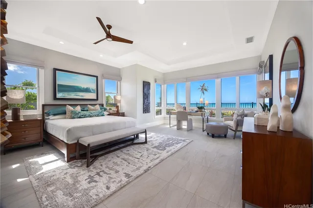 a bedroom with furniture large window and a potted plant