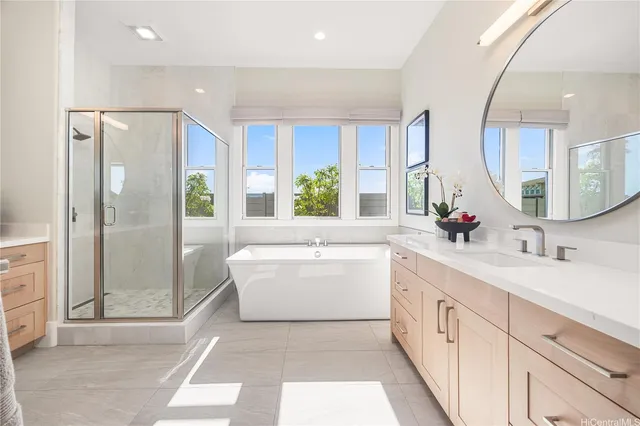 a bathroom with a tub sink shower and mirror