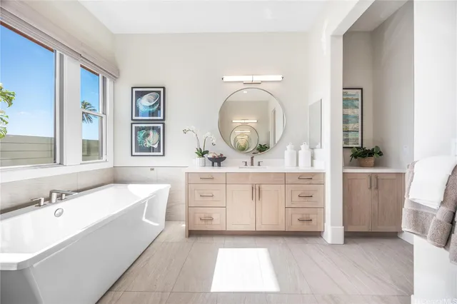 a bathroom with a tub sink and mirror