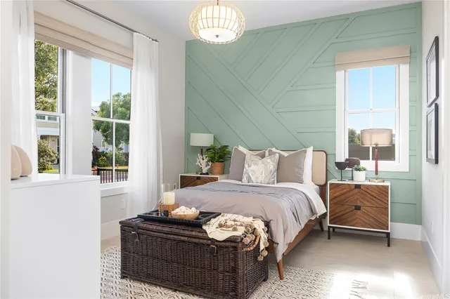 a bed sitting in a bedroom next to a window