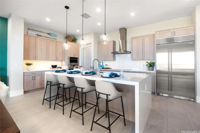 a kitchen with kitchen island granite countertop a sink cabinets and stainless steel appliances