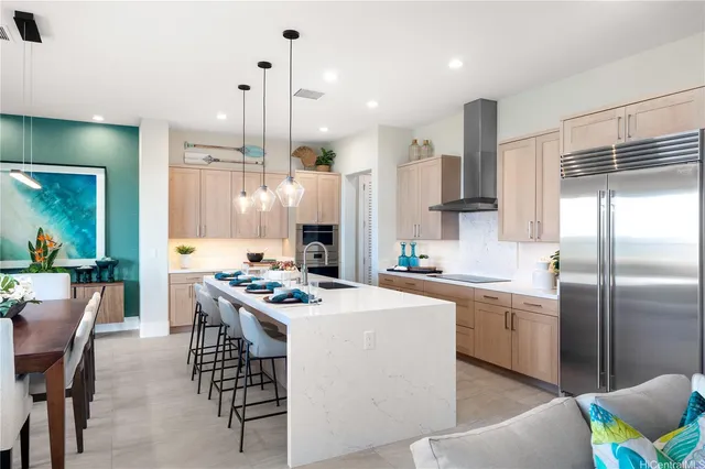 a kitchen with a sink a stove a refrigerator and chairs