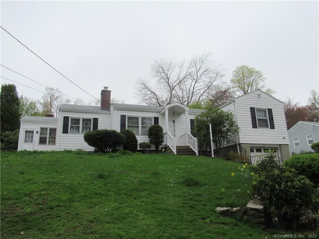 2 Entrance Road Milford, CT 06460 - Photo 1 of 1 a front view of a house with a garden and trees