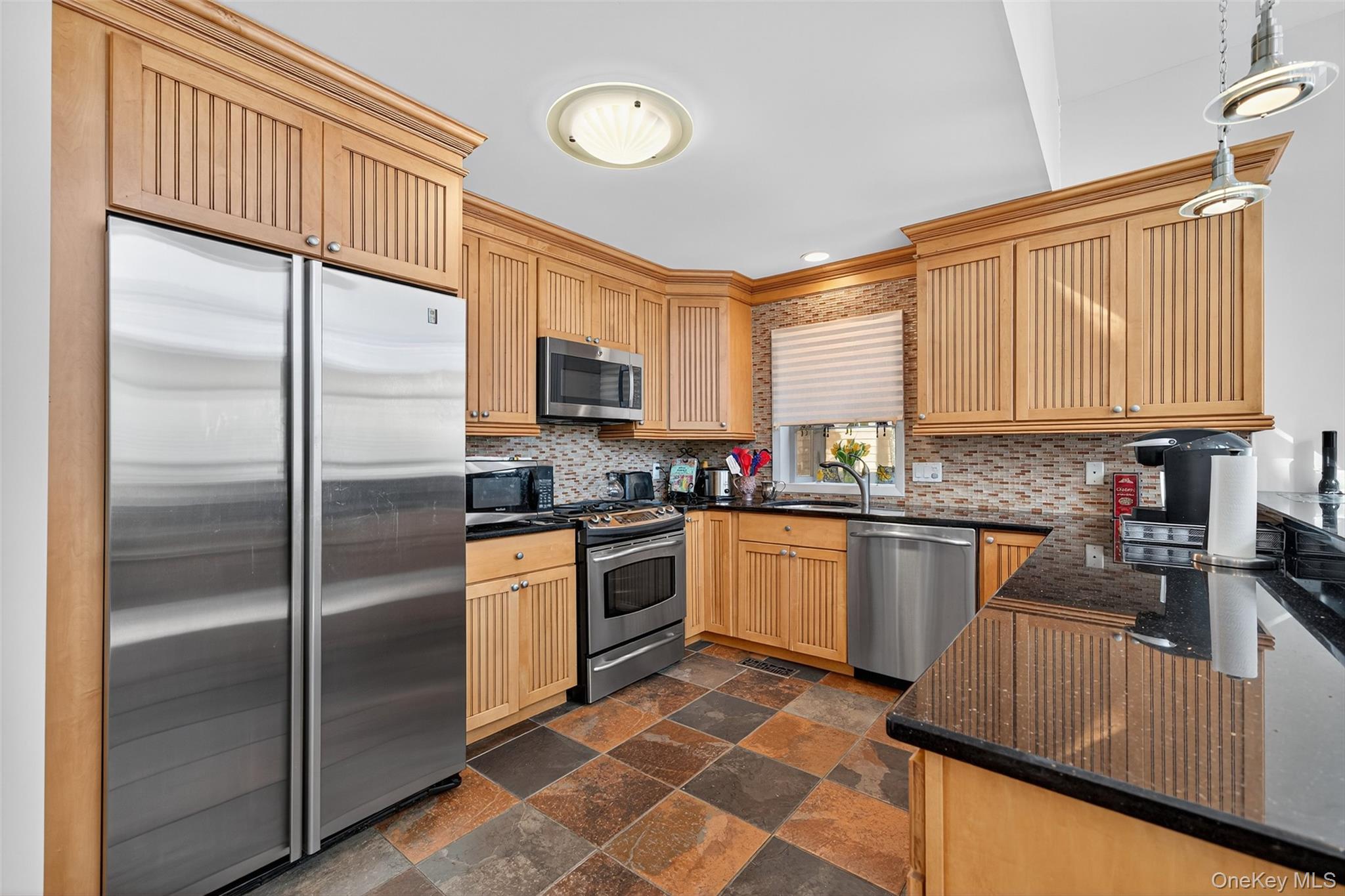 518 Sackett Lake Road Monticello, NY 12701 - Photo 12 of 44 a kitchen with granite countertop stainless steel appliances a sink cabinets and a window