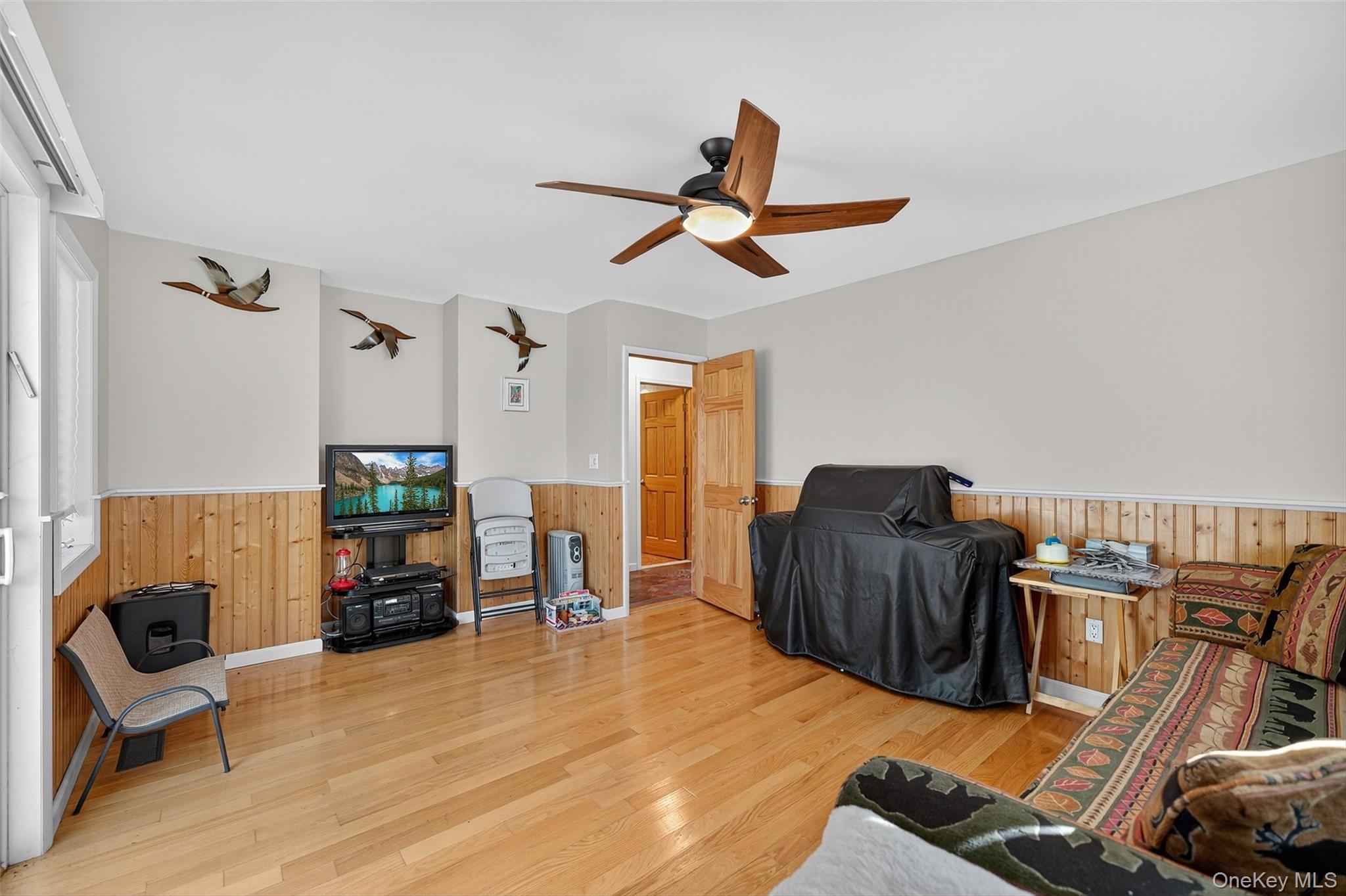 518 Sackett Lake Road Monticello, NY 12701 - Photo 26 of 44 a living room with furniture and a wooden floor