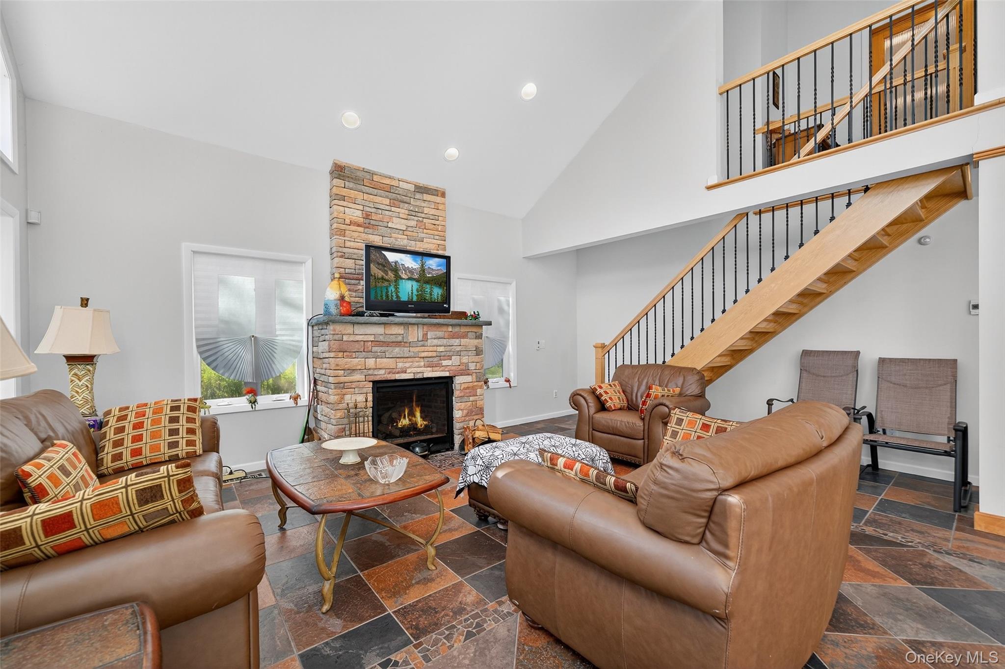 518 Sackett Lake Road Monticello, NY 12701 - Photo 27 of 44 a living room with furniture a fireplace and a large mirror