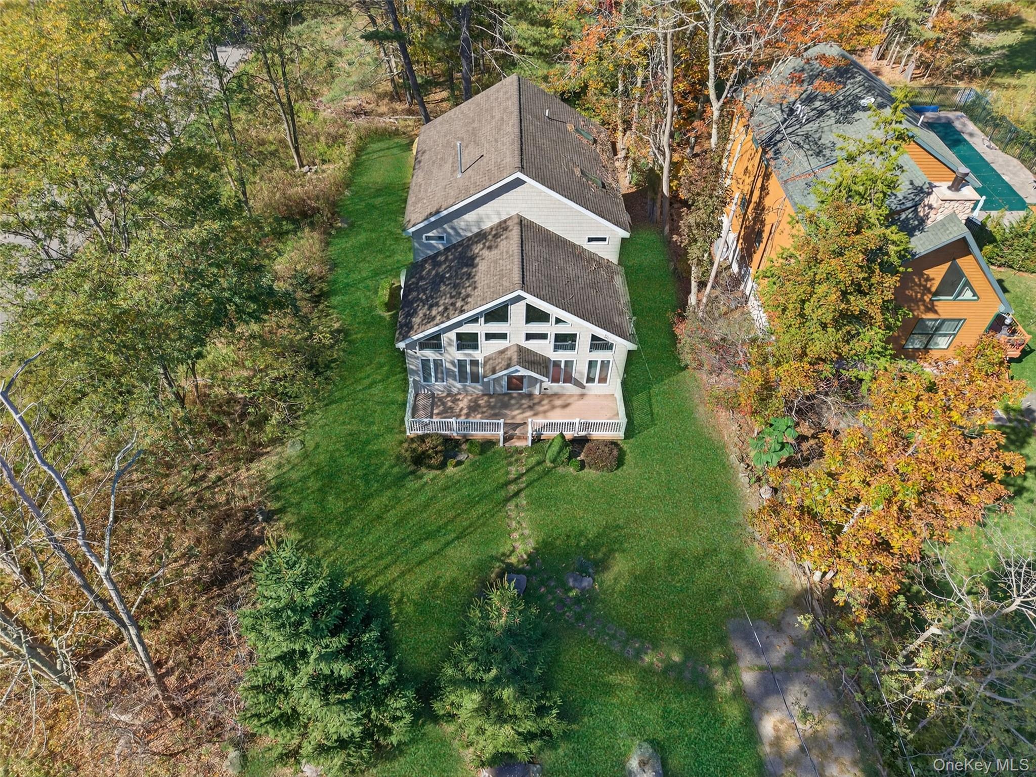 518 Sackett Lake Road Monticello, NY 12701 - Photo 5 of 44 a view of a big yard with plants and large trees