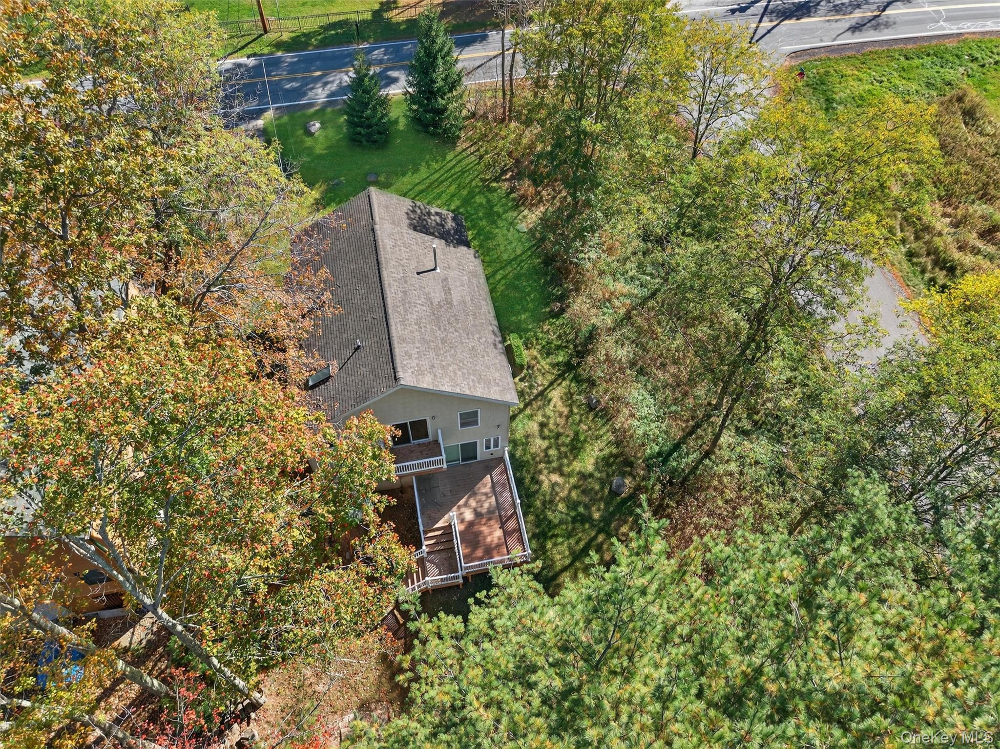 518 Sackett Lake Road Monticello, NY 12701 - Photo 7 of 44 an aerial view of a house with a yard and trees