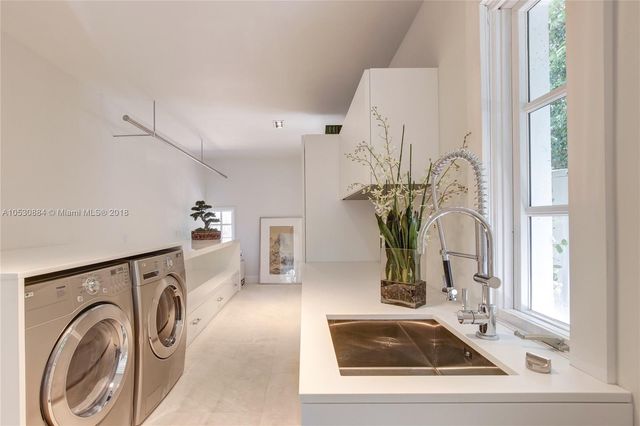 a bedroom with two beds and windows