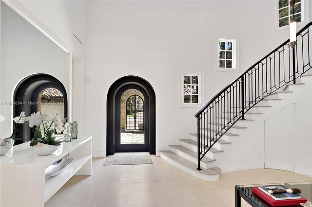 a view of a hallway with windows and stairs