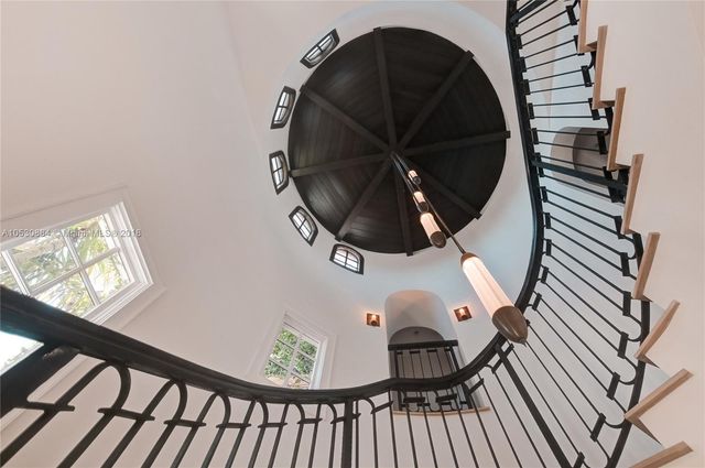 a bedroom with a large bed and a flat tv screen