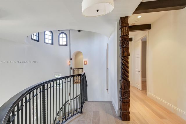 a bedroom with a large bed a flat tv screen and a book shelf