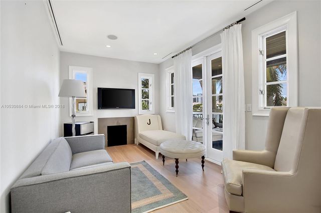 a room with stainless steel appliances kitchen island granite countertop a refrigerator and a sink