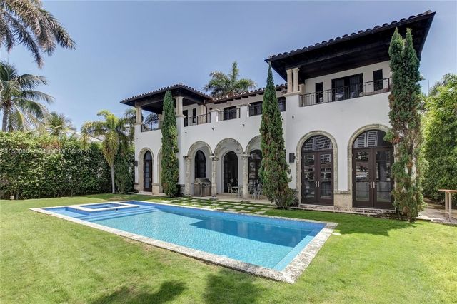 a front view of a house with yard and green space