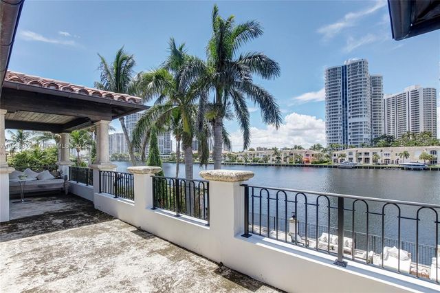 a bedroom with a balcony a bed and a window