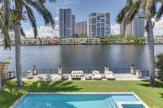 a bedroom with a bed and a flat tv screen on wall