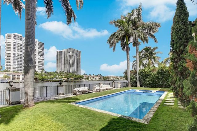 a view of a swimming pool with a yard