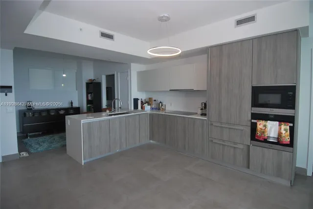 a kitchen with counter top space and stainless steel appliances