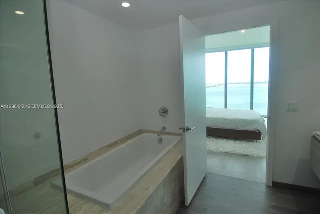 a bathroom with a bathtub and a shower