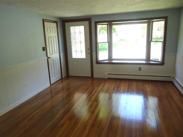 22 Millbrook Road Bourne, MA 02532 - Photo 7 of 25 an empty room with wooden floor and windows
