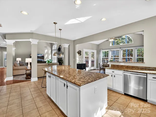 a kitchen with stainless steel appliances granite countertop a stove and more cabinets
