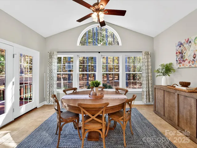 a dining room with furniture a rug and a large window