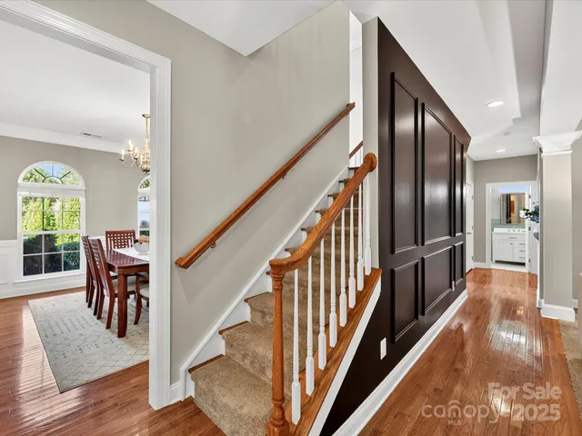 a view of a hallway view with wooden floor and staircase