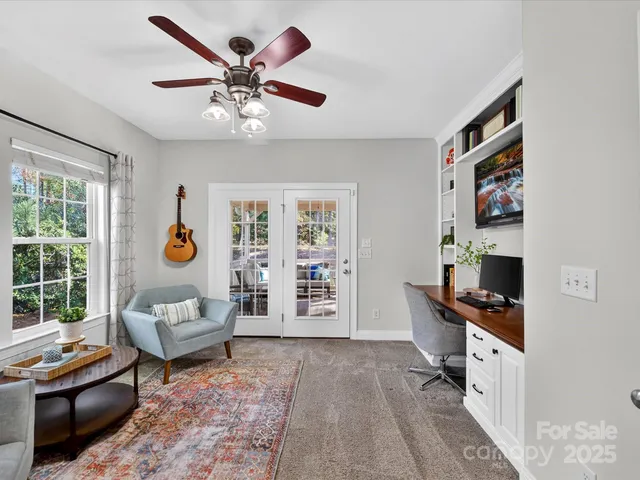 a living room with furniture a rug and a window