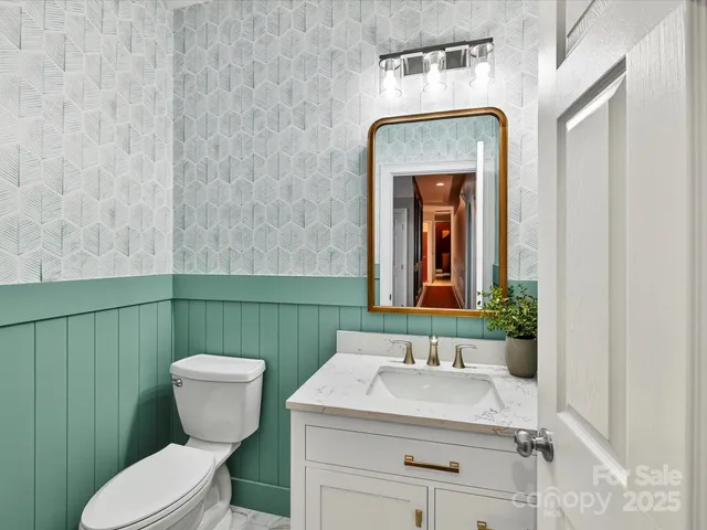 a bathroom with a sink a toilet and mirror