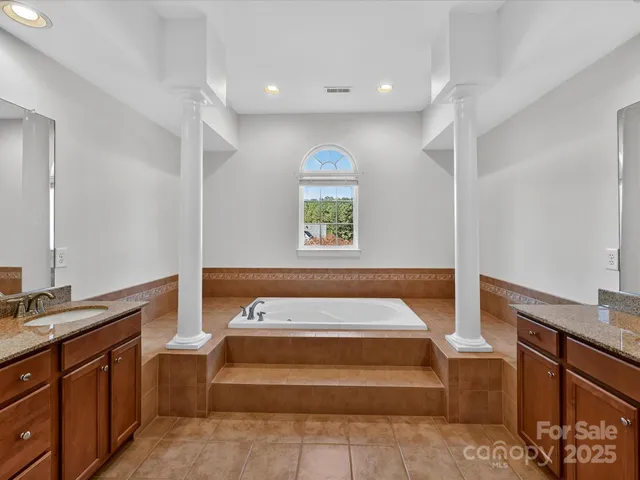 a spacious bedroom with a bed and a window