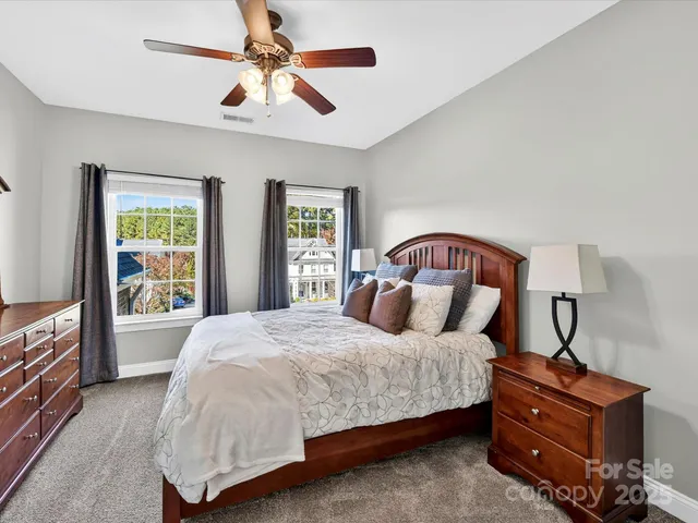 a bedroom with a bed dresser and a window