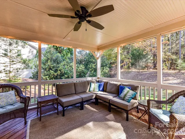 a roof deck with couches and potted plants