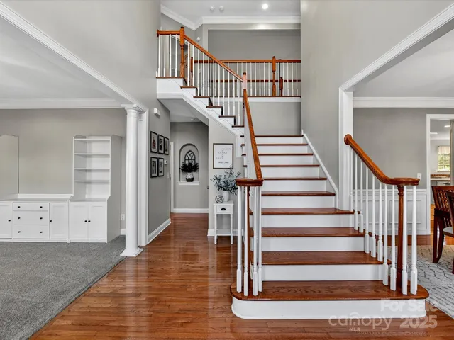 a view of entryway and hall with wooden floor
