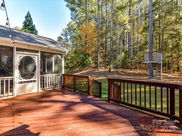 a view of a house with backyard and deck