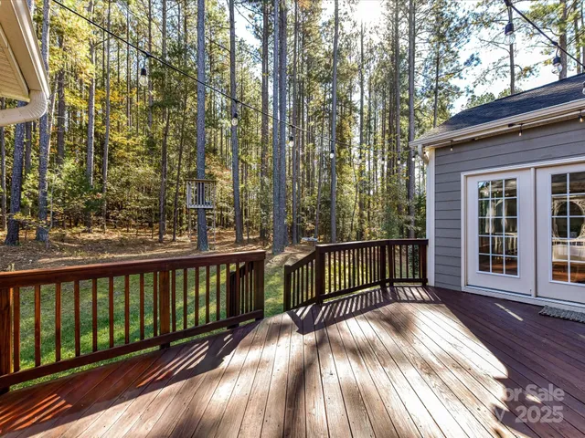 a view of balcony with wooden floor and fence