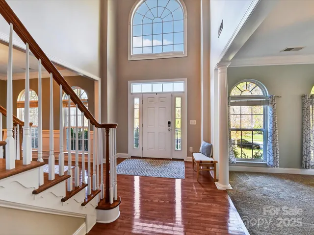 a view of an entryway with wooden floor and a front door