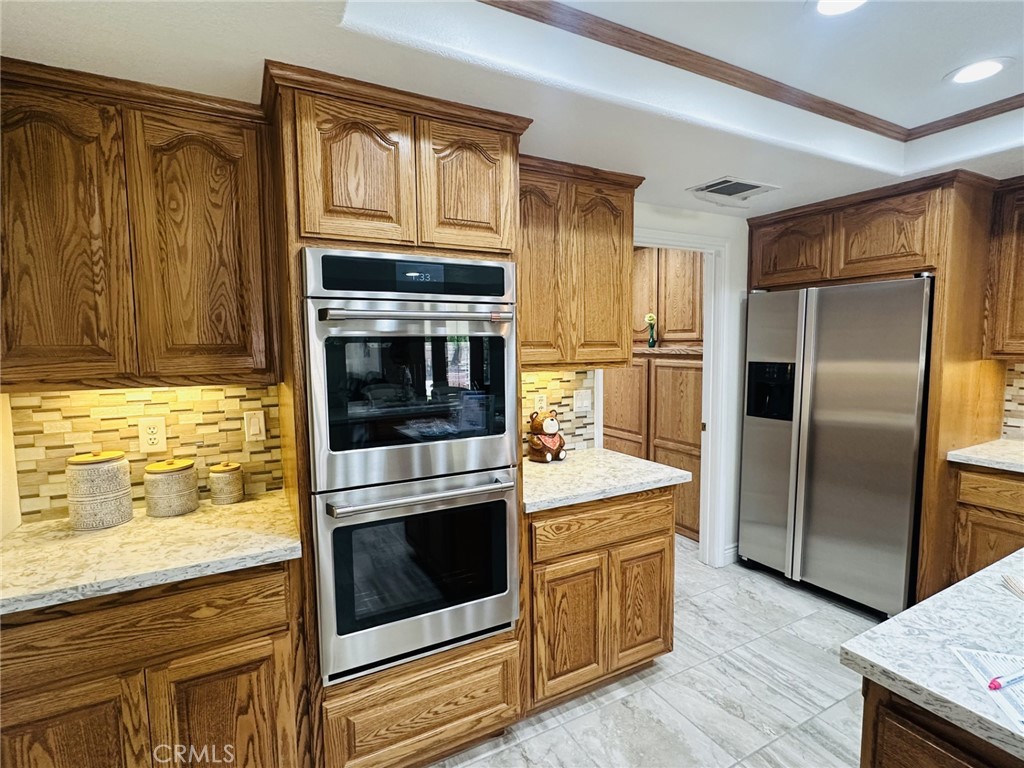 16232 Ridge View Drive Apple Valley, CA 92307 - Photo 25 of 66 a kitchen with granite countertop stainless steel appliances and wooden cabinets
