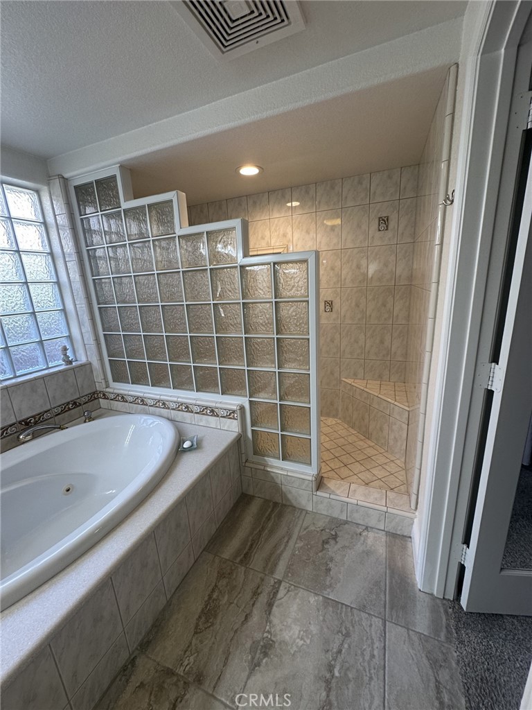 16232 Ridge View Drive Apple Valley, CA 92307 - Photo 47 of 66 a bathroom with a tub sink and shower