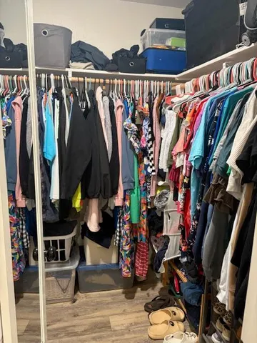 a view of a workspace with furniture and wooden floor