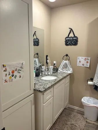 a view of a workspace with furniture and wooden floor